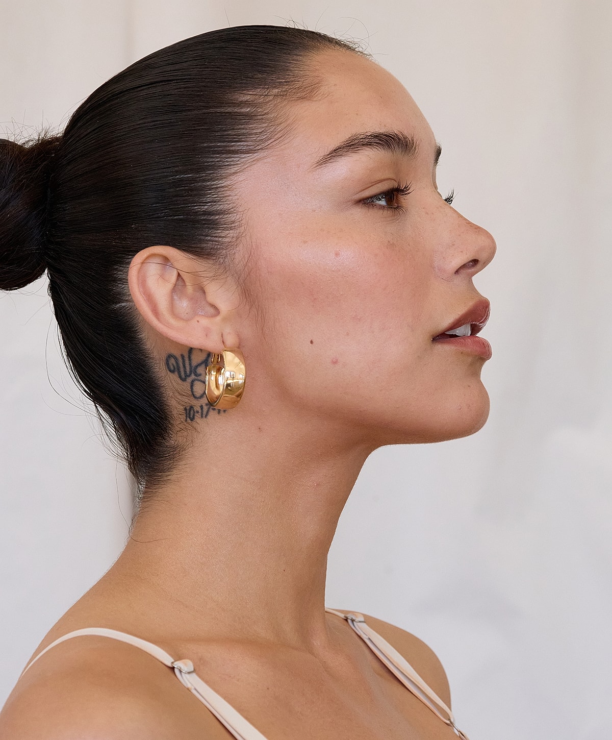Profile of a woman with hoop earrings.