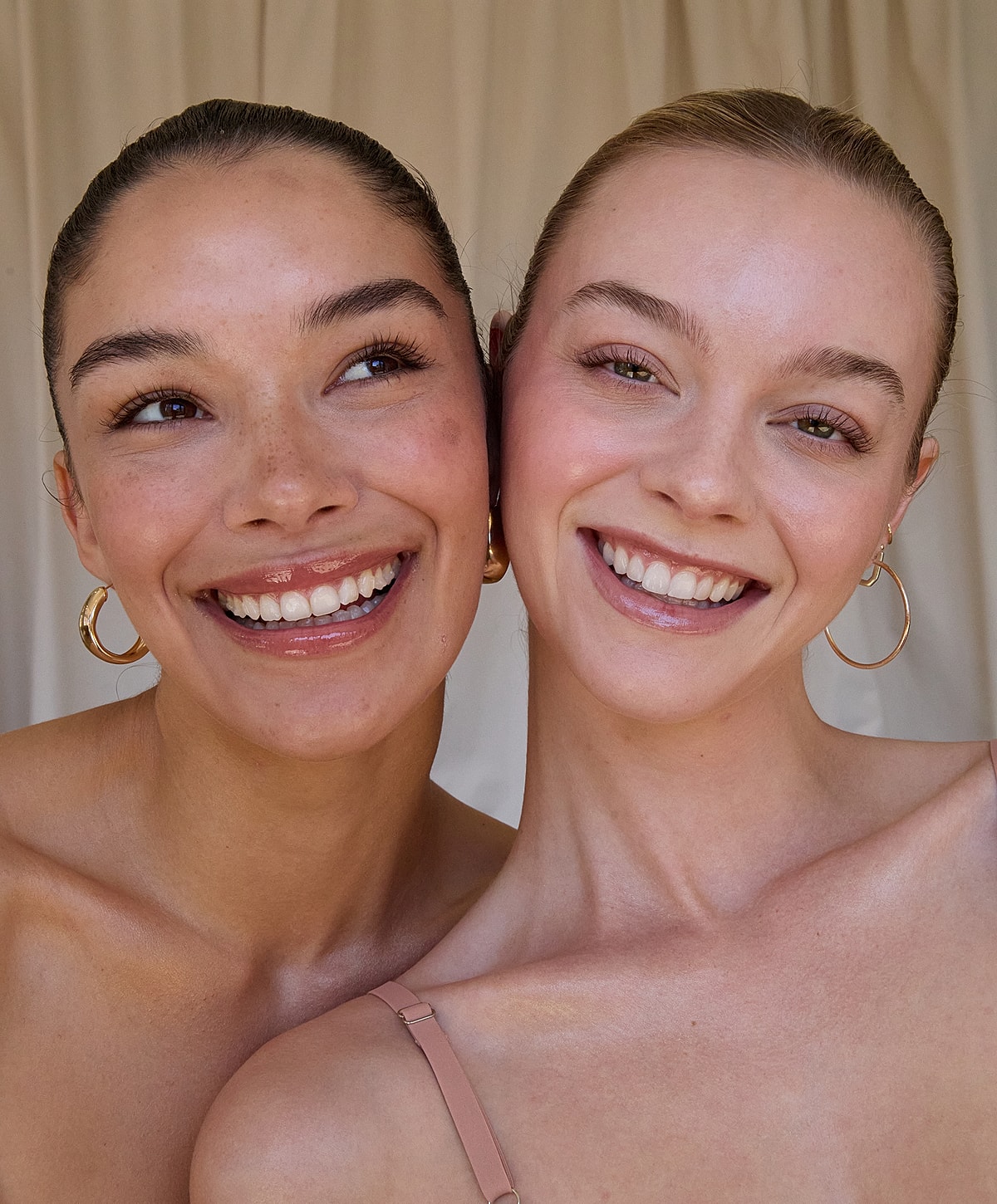 Two smiling women with natural makeup.