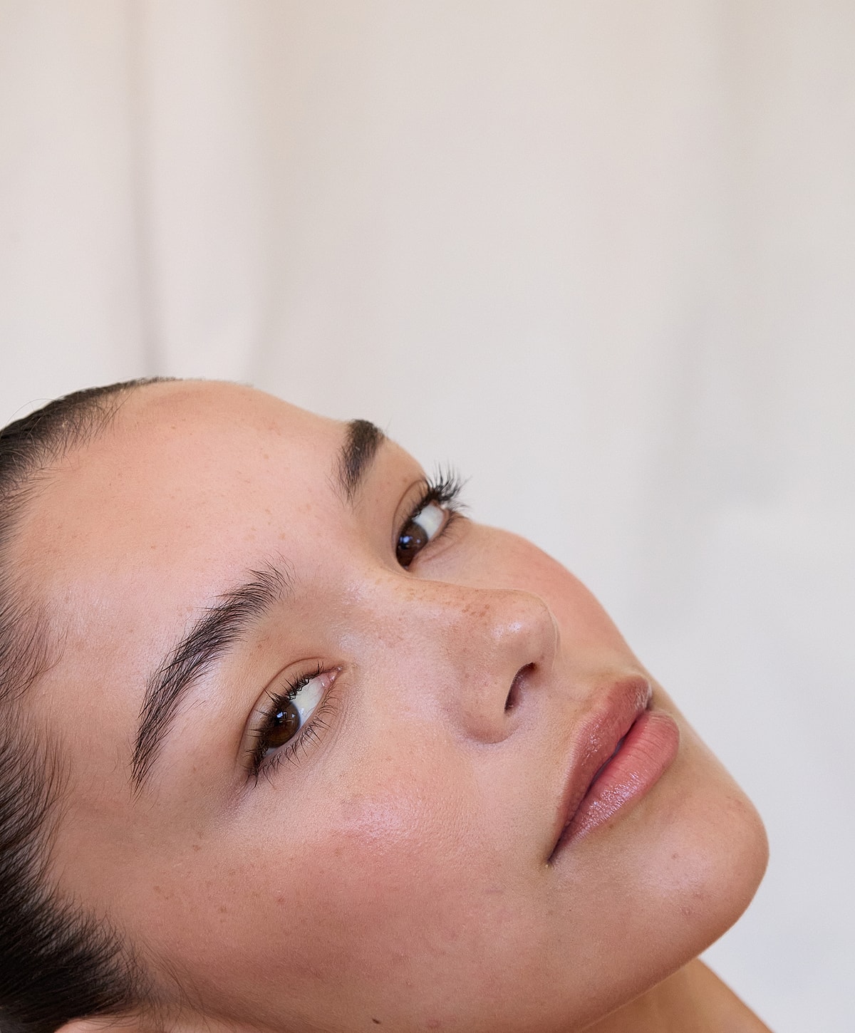 Woman's face with natural makeup and soft expression.