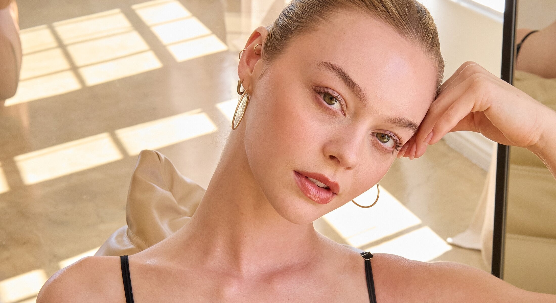 Young woman with light makeup and golden earrings